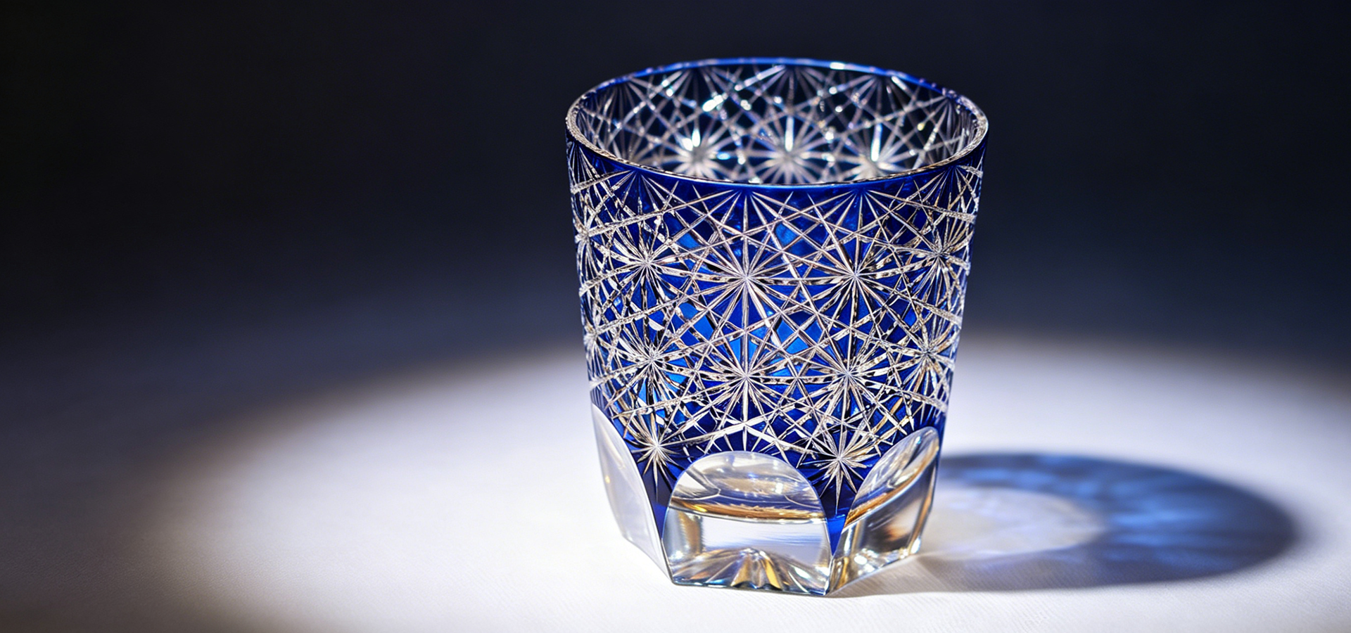 Artistic display of assorted vintage glassware with warm lighting casting natural shadows.